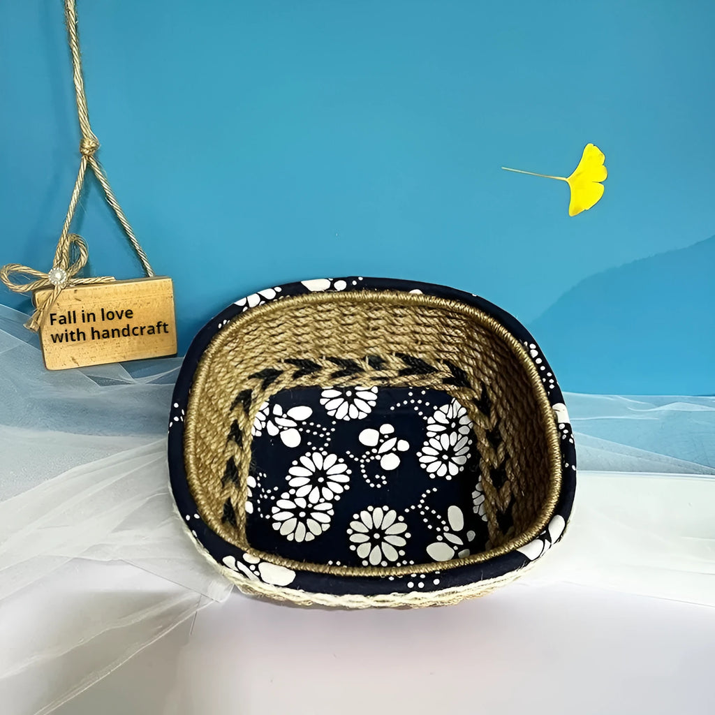 Blue square plastic storage basket with woven texture on a wooden tabletop.