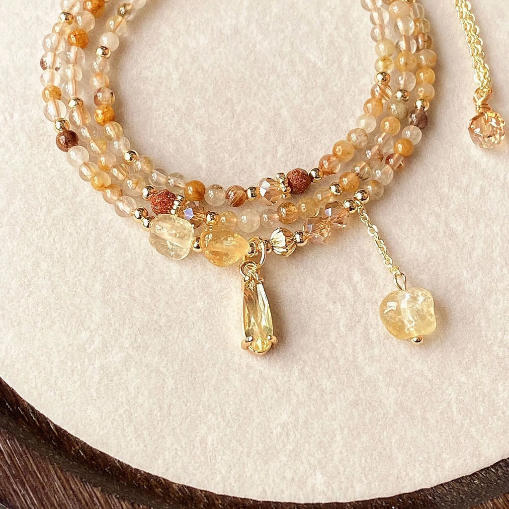 Women's natural citrine bracelet with three interconnected circles in caramel gold colour featuring Saturn design elements