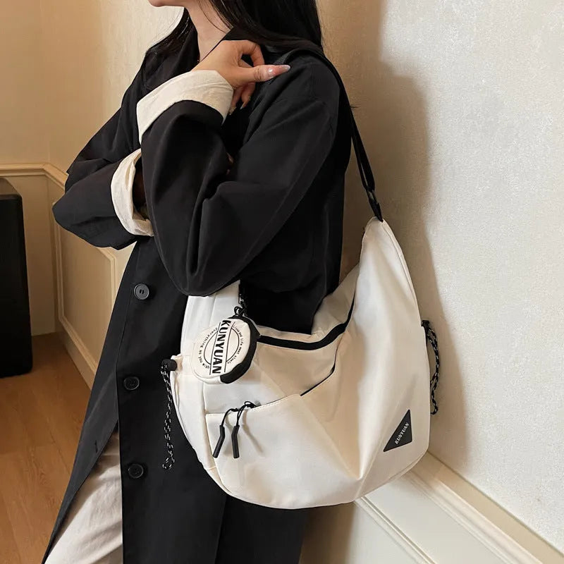 Soft cloth crossbody bag in beige with sandwich pocket and sewing line detail for daily use