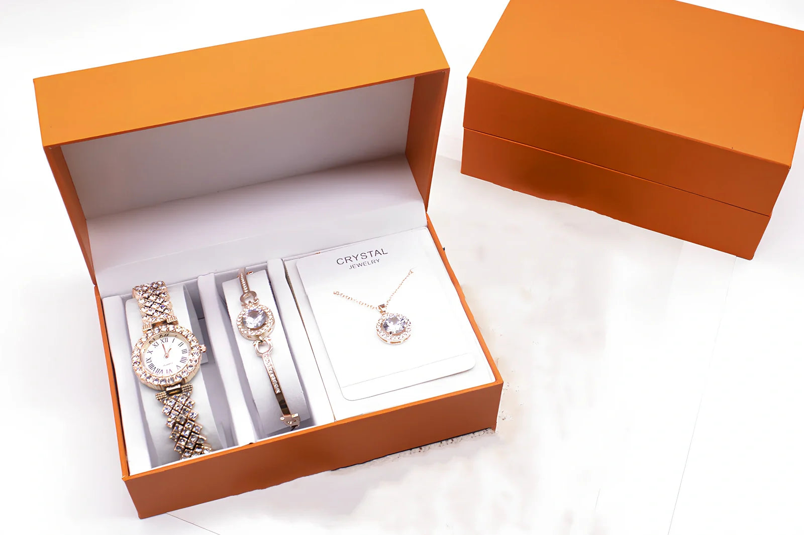 3-piece rhinestone quartz watch set with 22.5cm gold alloy strap, bracelet, and necklace on display