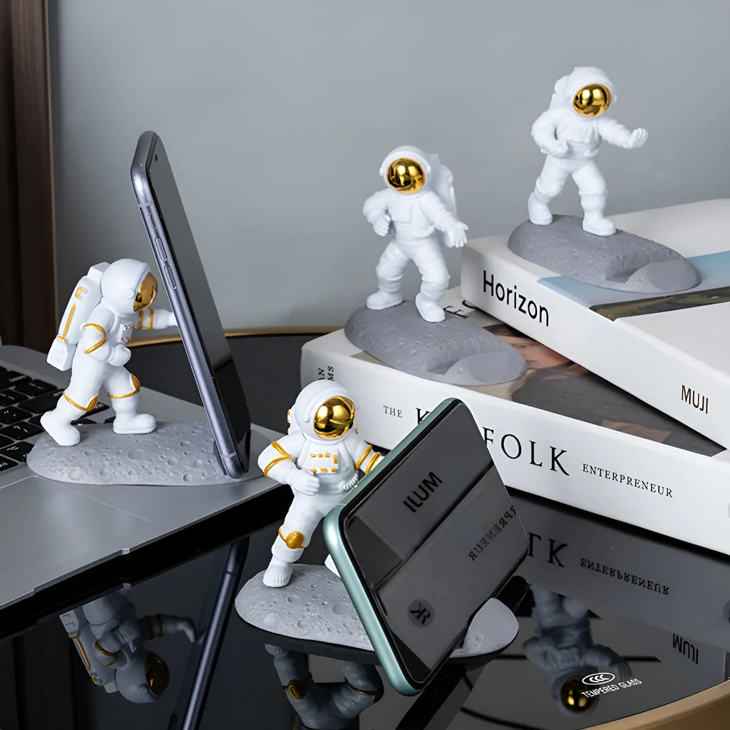 Plastic astronaut decoration mobile phone holder in blue colour on a desk