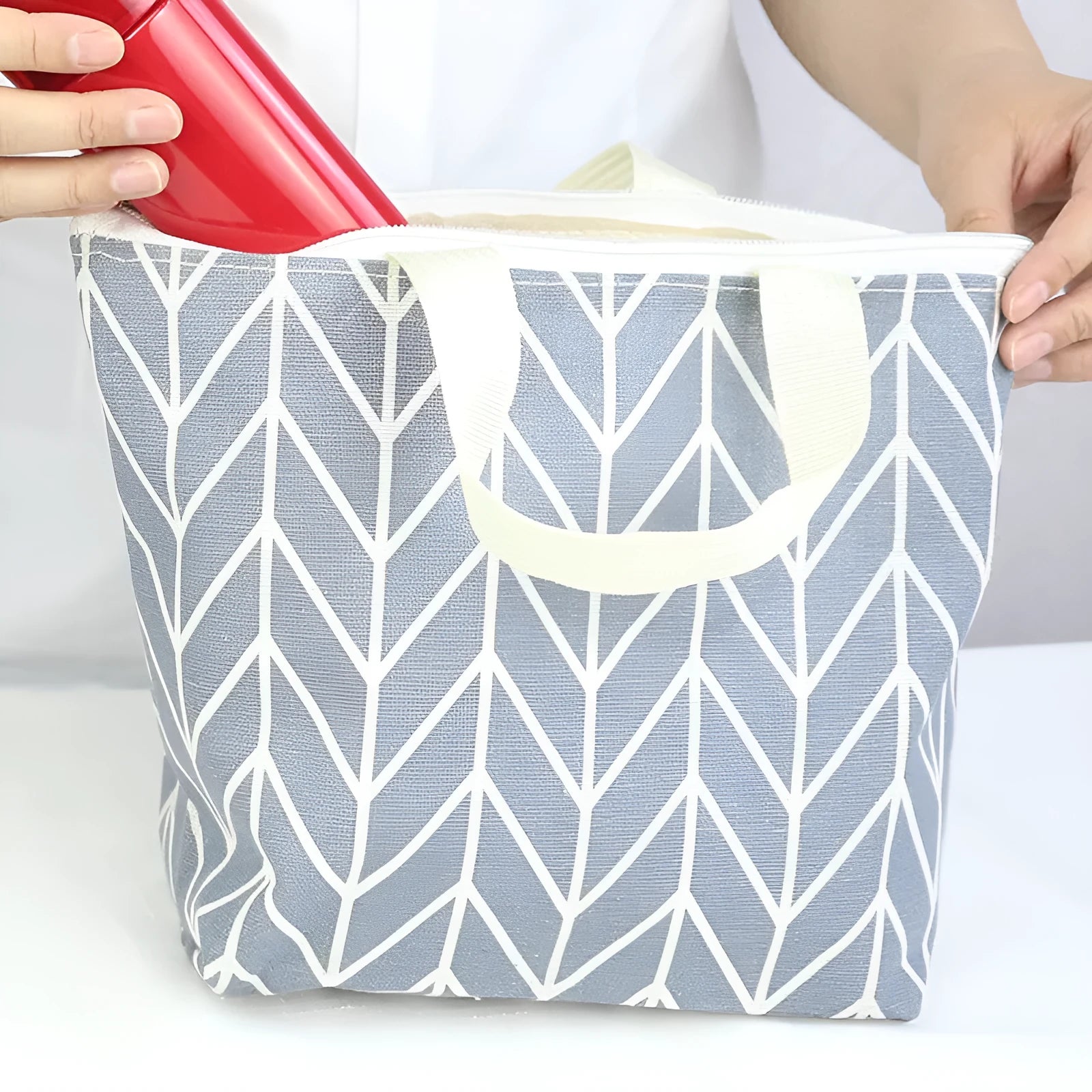 Arrow print polyester makeup bag with zipper open, showing light-coloured moisture-resistant interior lining.