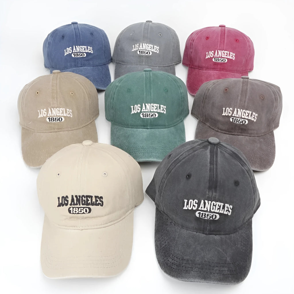Personalised retro-style peaked cap with embroidered letters on distressed fabric in beige colour.