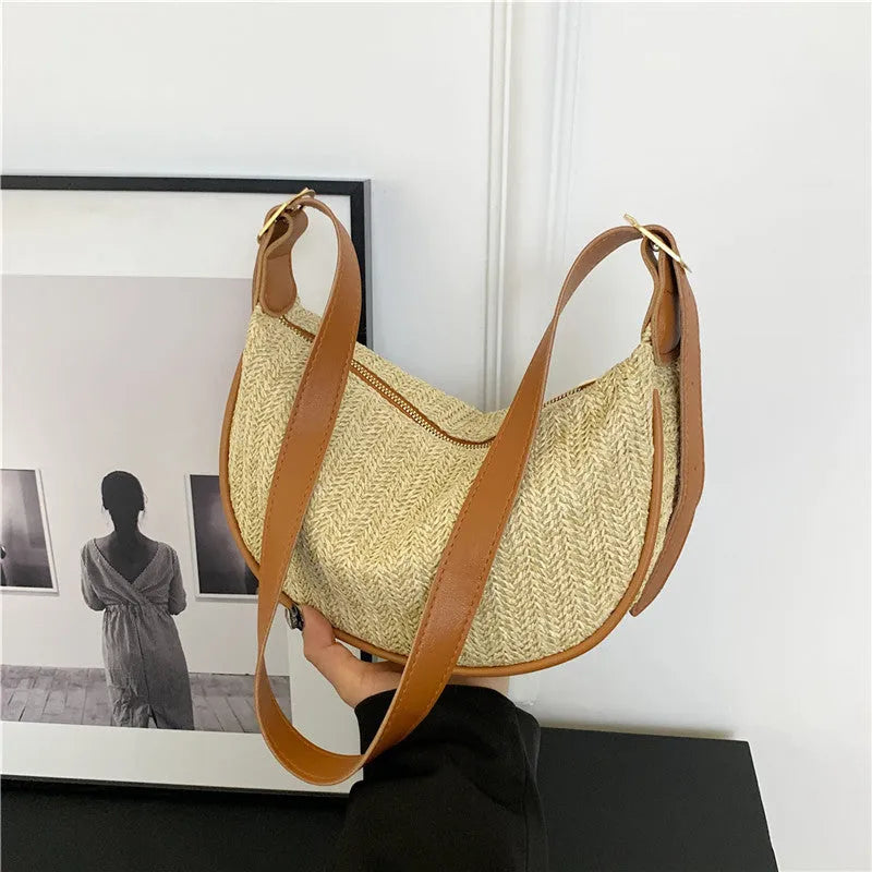 Women's woven straw crossbody bag showing textured surface and internal phone pocket