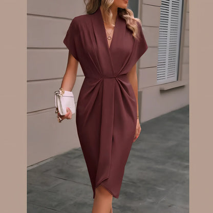 Black V-neck batwing sleeve polyester dress with pleated A-line skirt, mid-length 94cm in size M, showing shrug sleeves and solid colour fabric