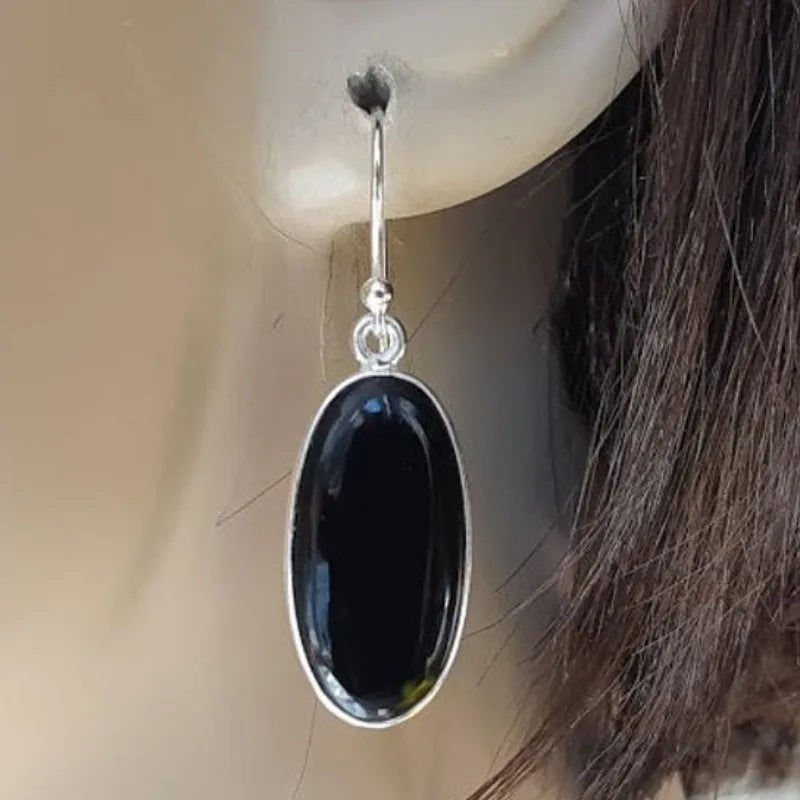 Women's geometric earrings with black agate oval pendants and silver electroplated finish