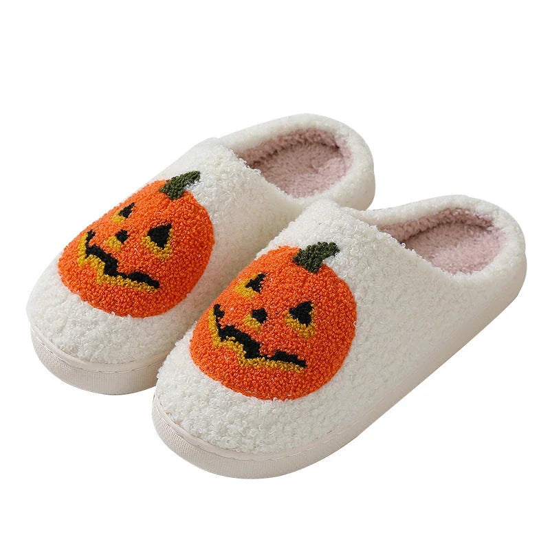 Cozy Halloween-themed pumpkin slippers in white and black colors, featuring soft suede uppers and durable rubber soles for indoor wear