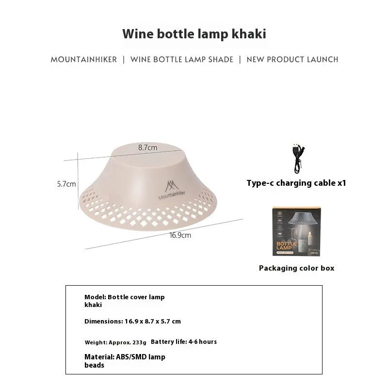 Beige wine bottle shaped camping lantern with USB-C port on a wooden table.