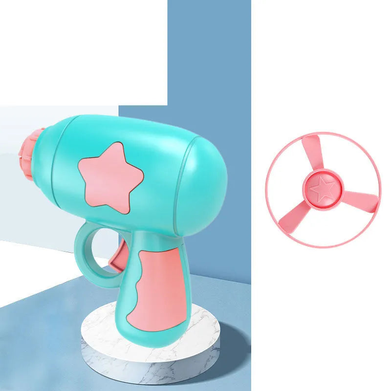 Plastic flying saucer launcher toy set with LED lights and coloured discs on outdoor grass.