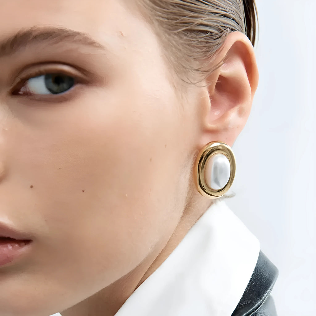 A pair of stainless steel vintage pearl ball stud earrings with surgical steel posts on a white background.