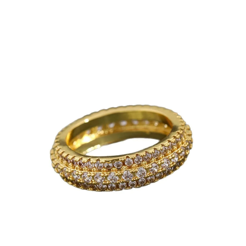 Geometric triangle zircon inlay ring in white gold, yellow gold, and white and black finishes on a copper band.