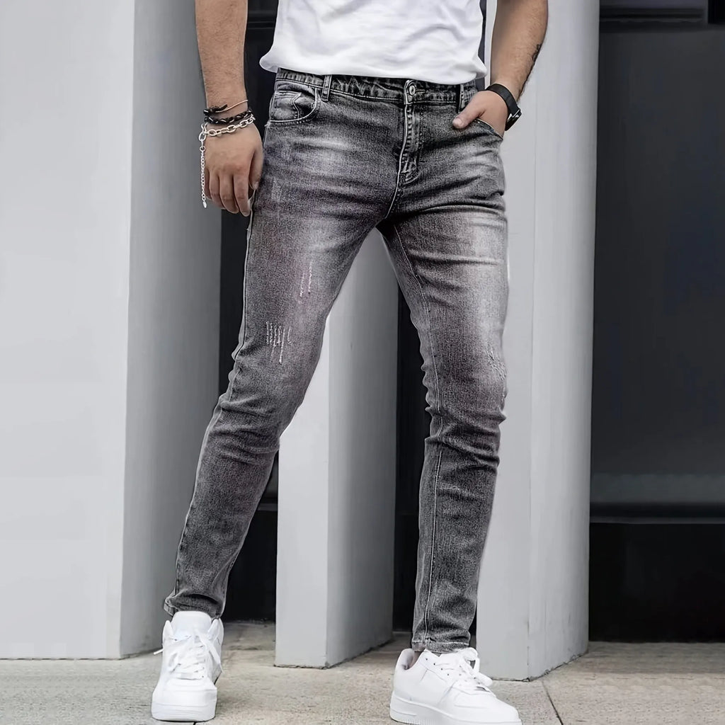 Men's black stretch jeans with straight leg and skinny opening, laid flat.