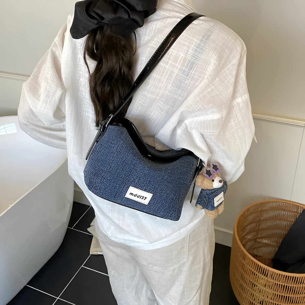 Denim small crossbody bag in black with slit pocket, horizontal square shape, medium hardness, polyester lining.