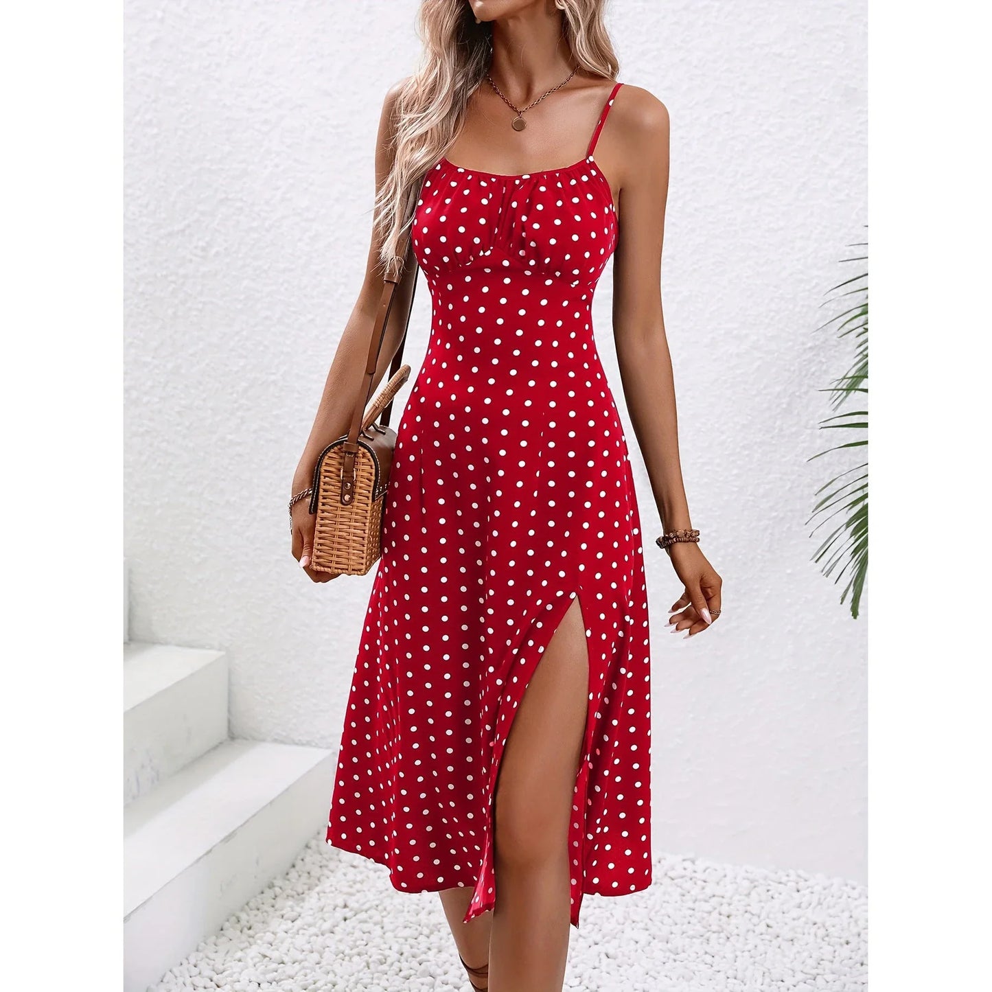 Stylish women's polka dot suspender dress with a sexy slit, perfect for summer outings.