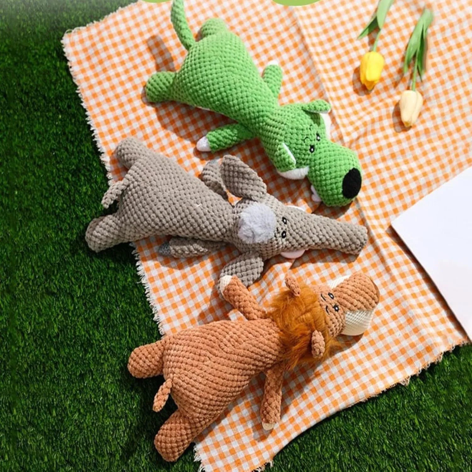 Green, grey, and yellow corn-shaped plush dog toys with a grunting sound device.