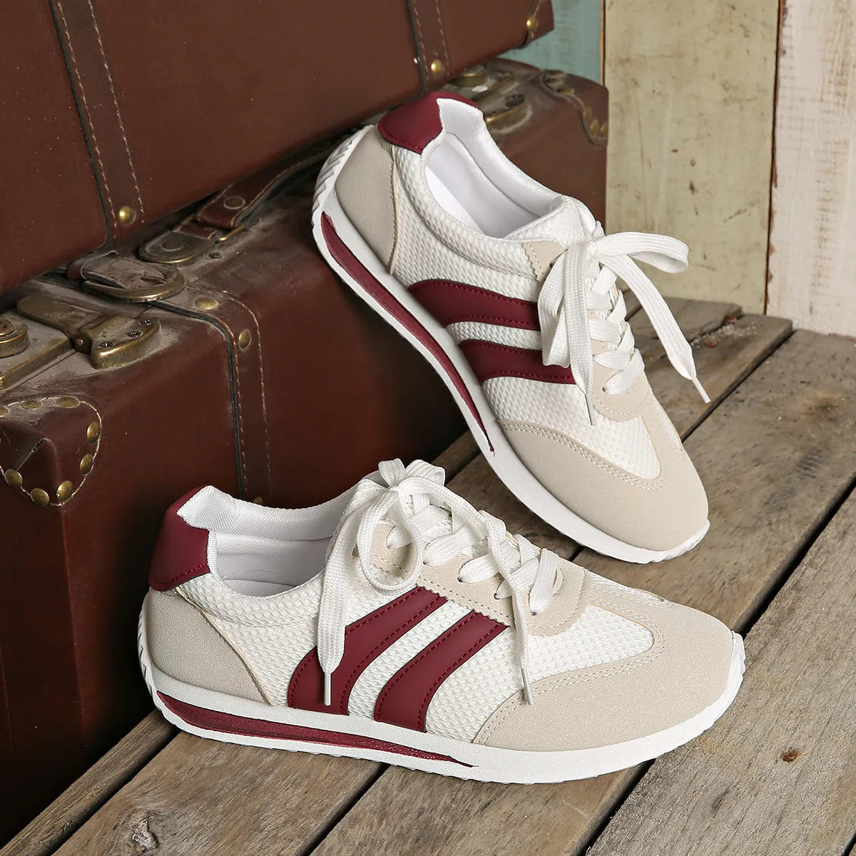 Wine red Cortez-style casual sneakers with a cross-strap detail and mesh lining.