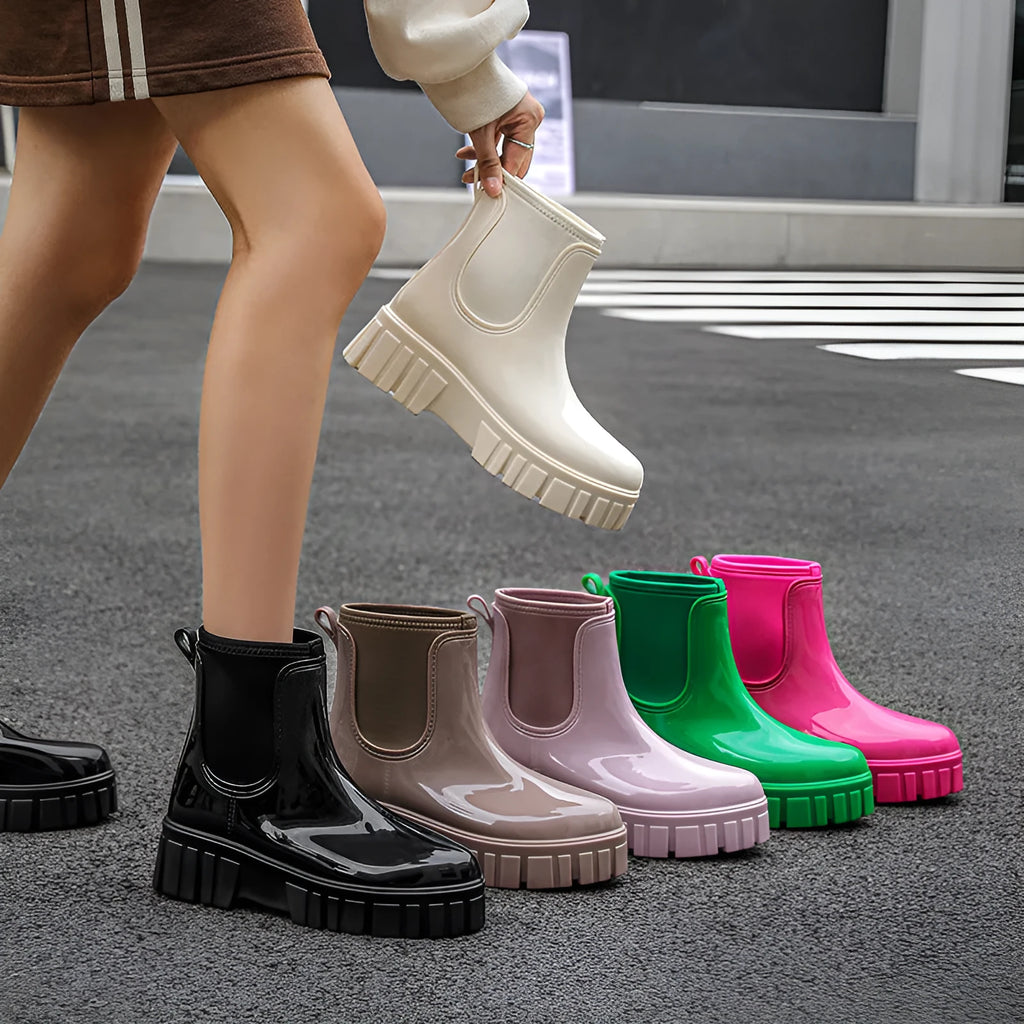 PVC low tube rain boot in solid colour with flat heel and non-slip sole.
