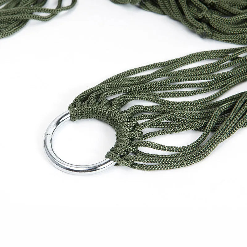Outdoor Supplies 9-strand nylon rope hammock in red hanging between trees in a garden