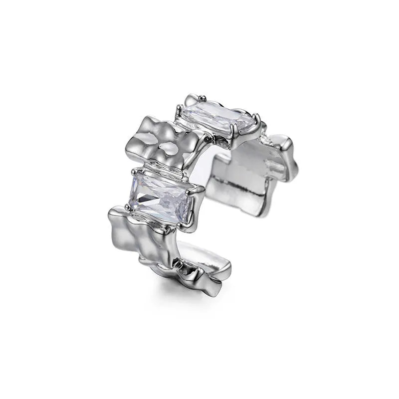 Silver geometric cross ring with open gemstone setting and retro national fashion decorative elements.