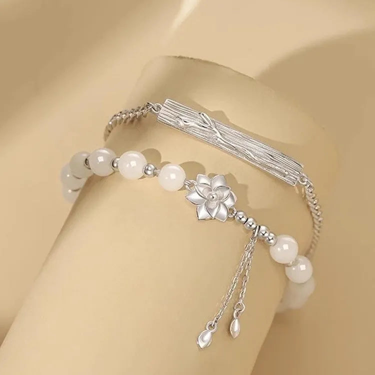 New Chinese style beaded bracelet with floral resin charms showing camellia, lotus and peach blossom designs
