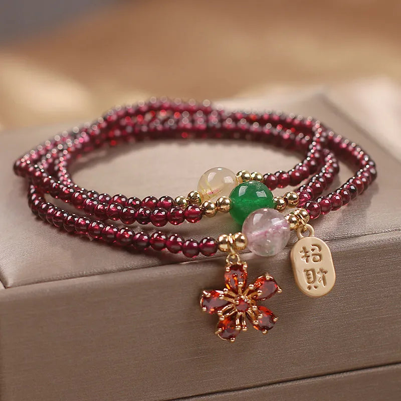 Natural crystal bracelet for women in pomegranate red cherry blossom colour with sequin detailing.
