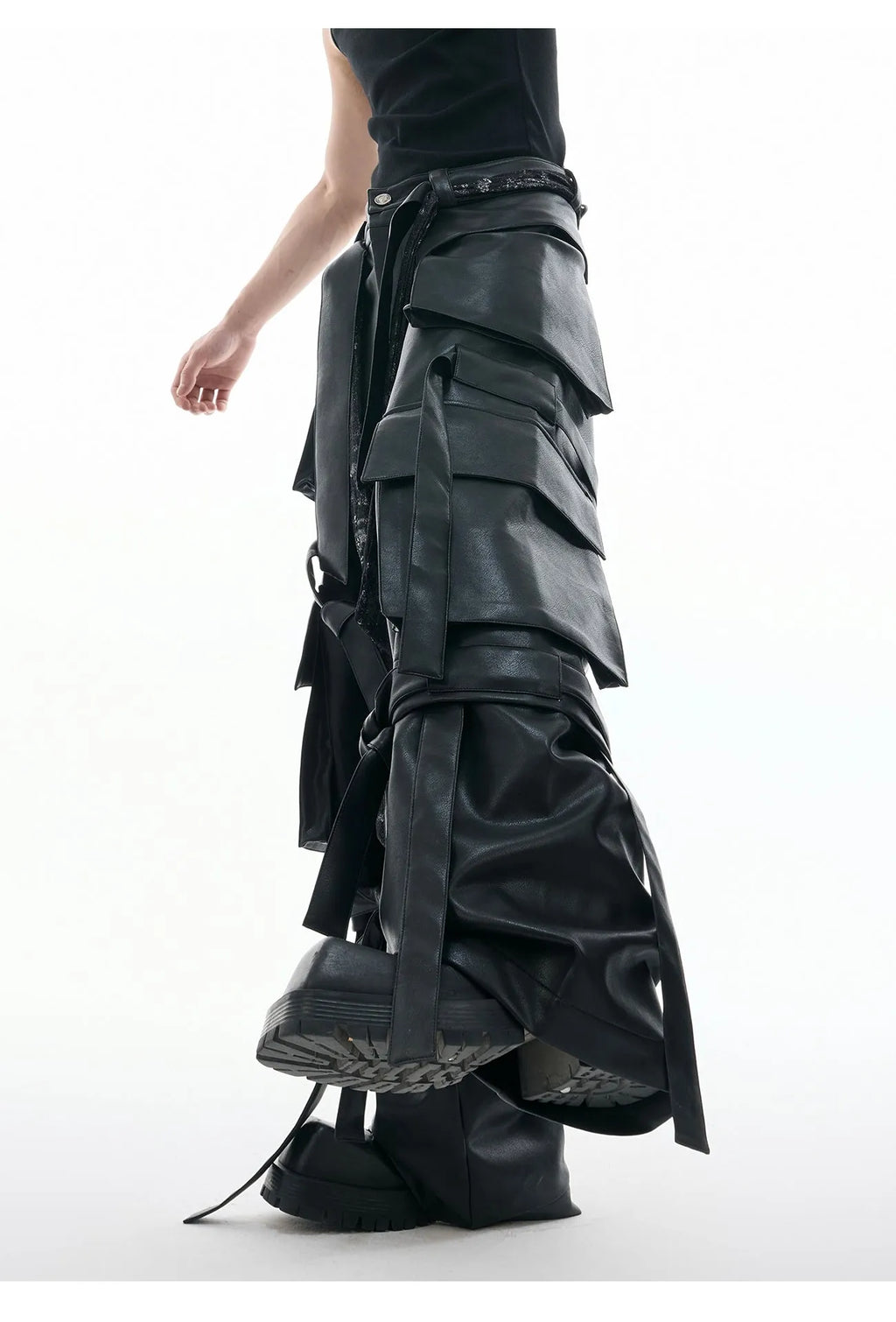 Black loose-fit leather-look trousers with multiple pockets, quilted panels, and ribbon trim details.