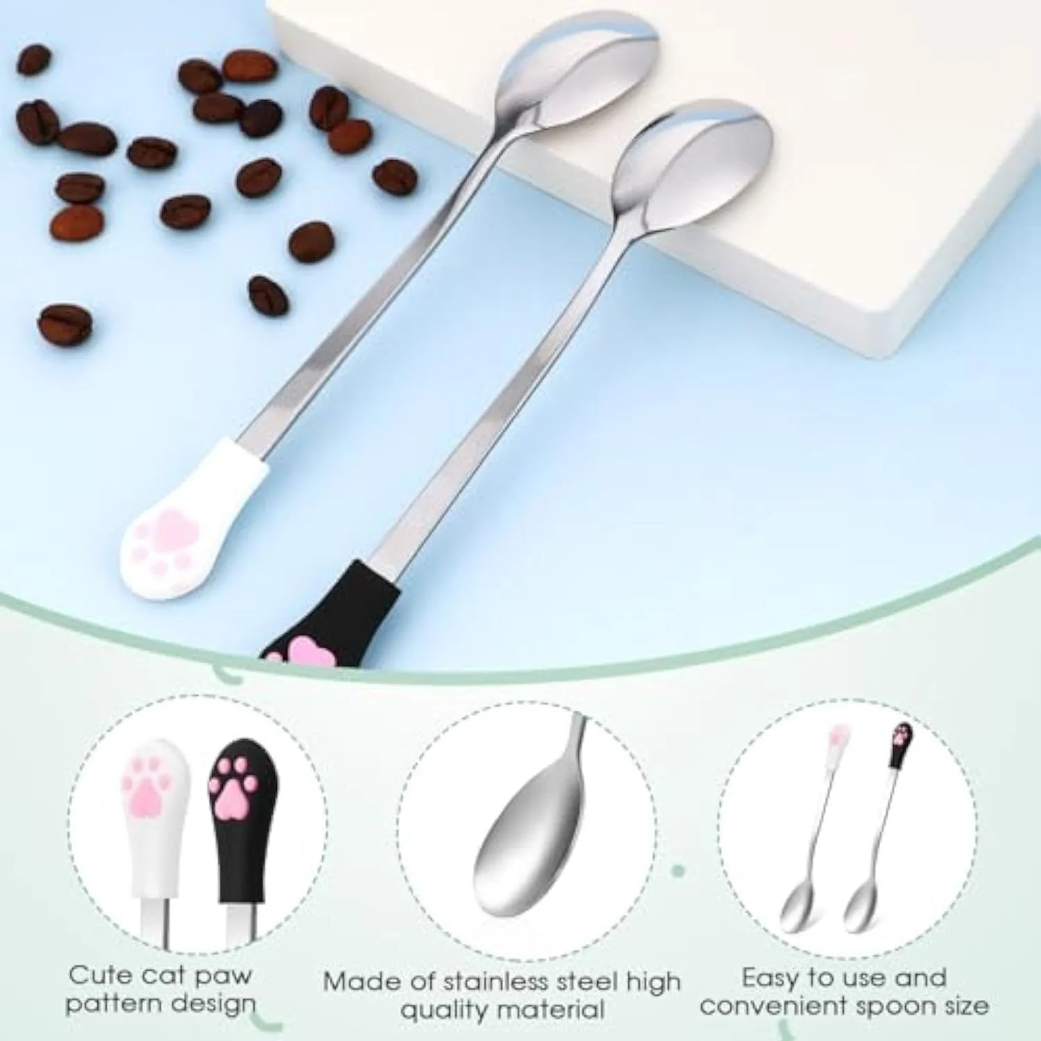 Two stainless steel pet food spoons with white and black silicone handles featuring a cat paw print design.