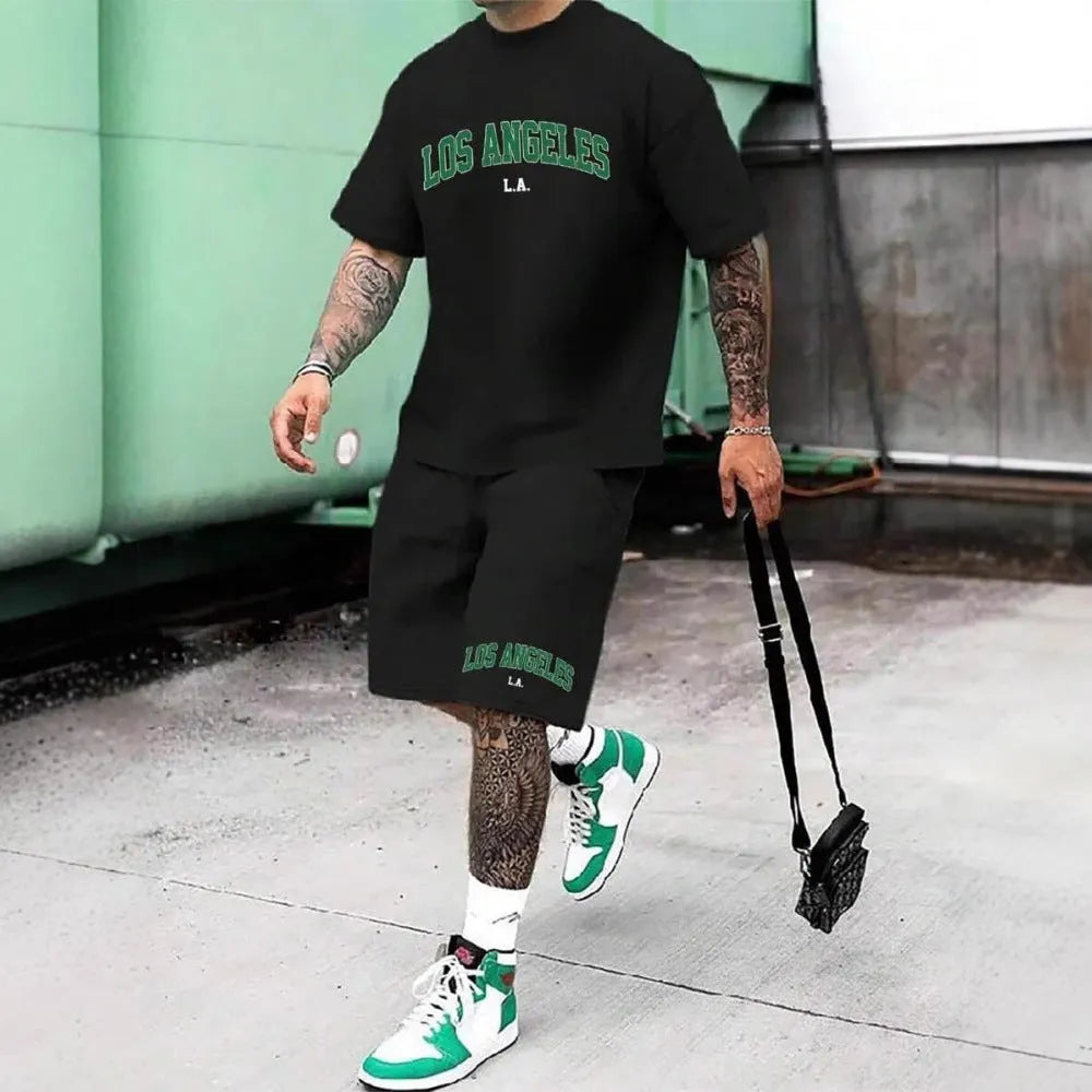 Man wearing a grey short sleeve top and matching shorts with a 3D printed white letter design.