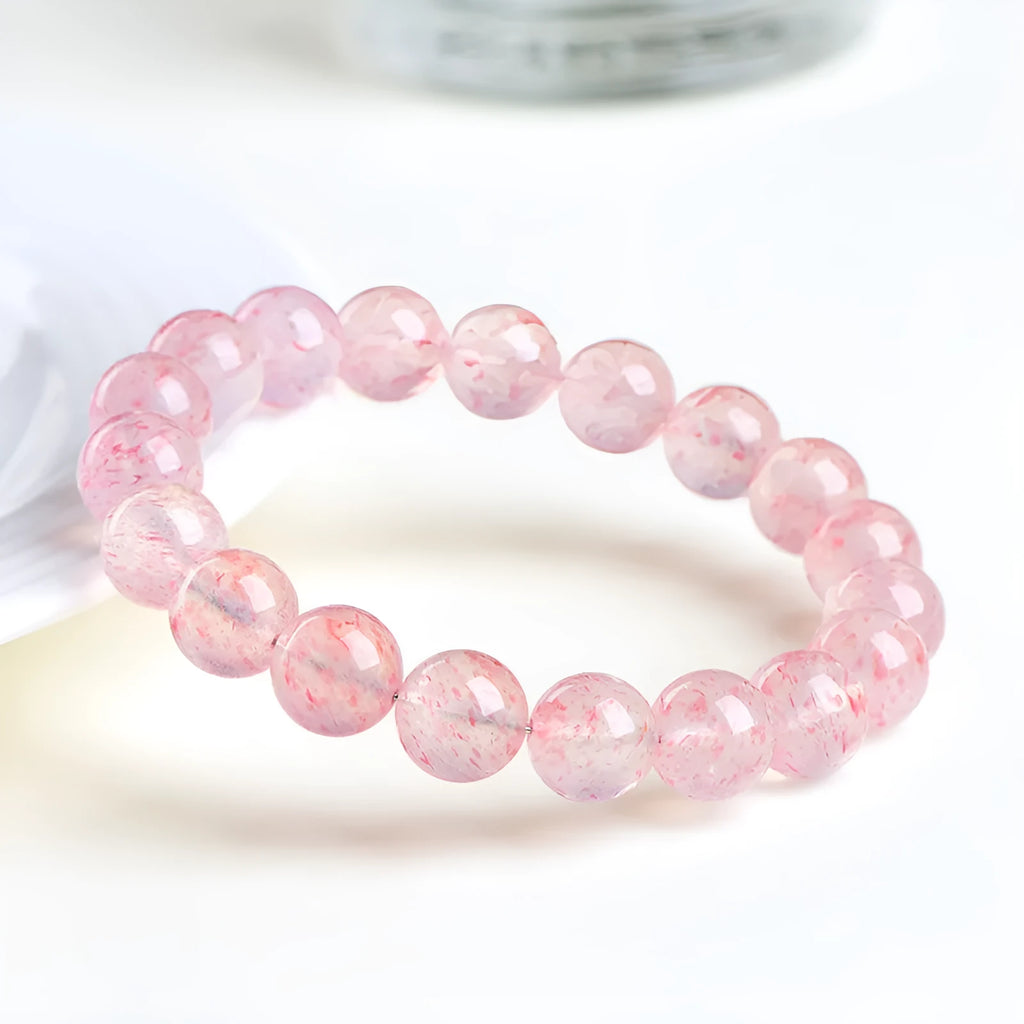 Natural strawberry quartz bracelet with white water crystal beads measuring 10-10.8mm