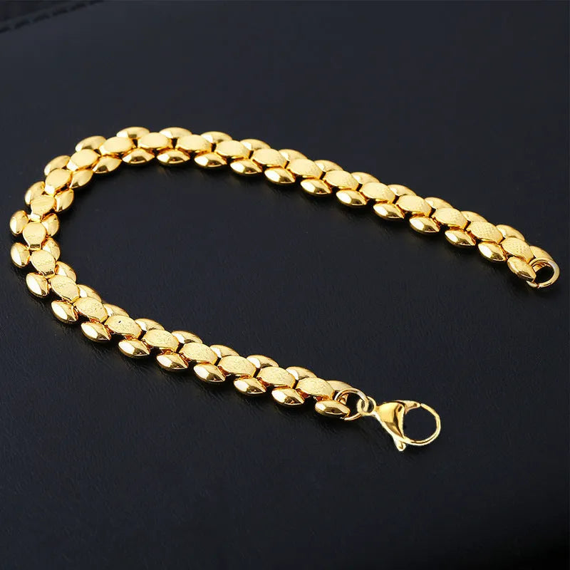 L254 Gold iron bracelet laid flat on a surface, showing its metallic finish and simple design.