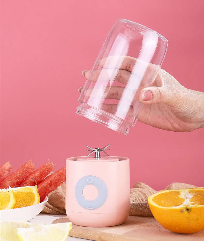 Mini USB automatic juicer in pink white and green colours with compact design 7x7x19.5cm