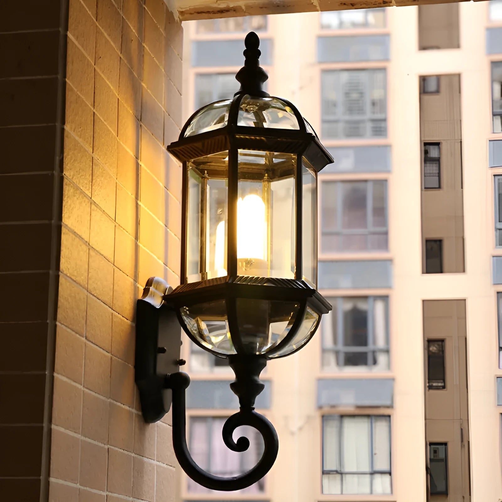 Outdoor aluminium wall lamp with three-layer design in black finish mounted on a courtyard wall