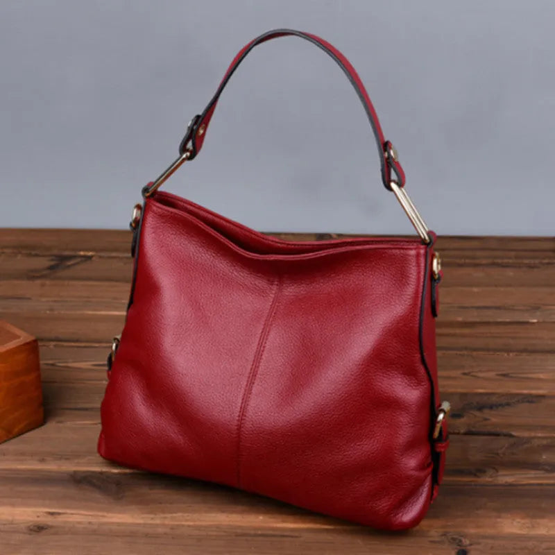 Genuine leather vertical square crossbody bag in black with multiple internal organiser pockets.