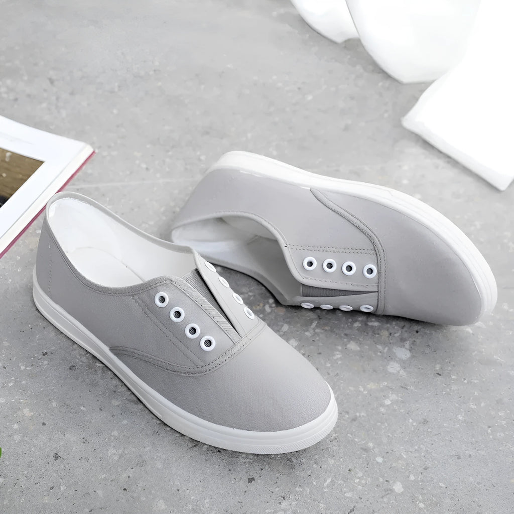 Low-top canvas trainers in black, white, grey and pink colours with plastic sole
