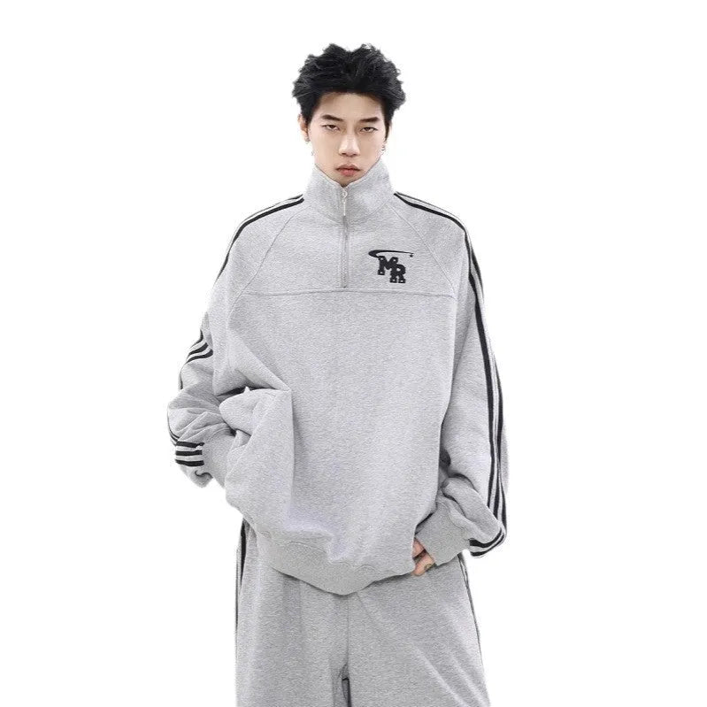 Black Hong Kong style stand collar couple sweater with long sleeves and a coat-style design.