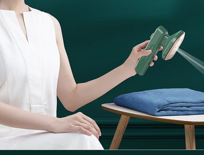 Green handheld garment steamer for quick ironing and sterilisation