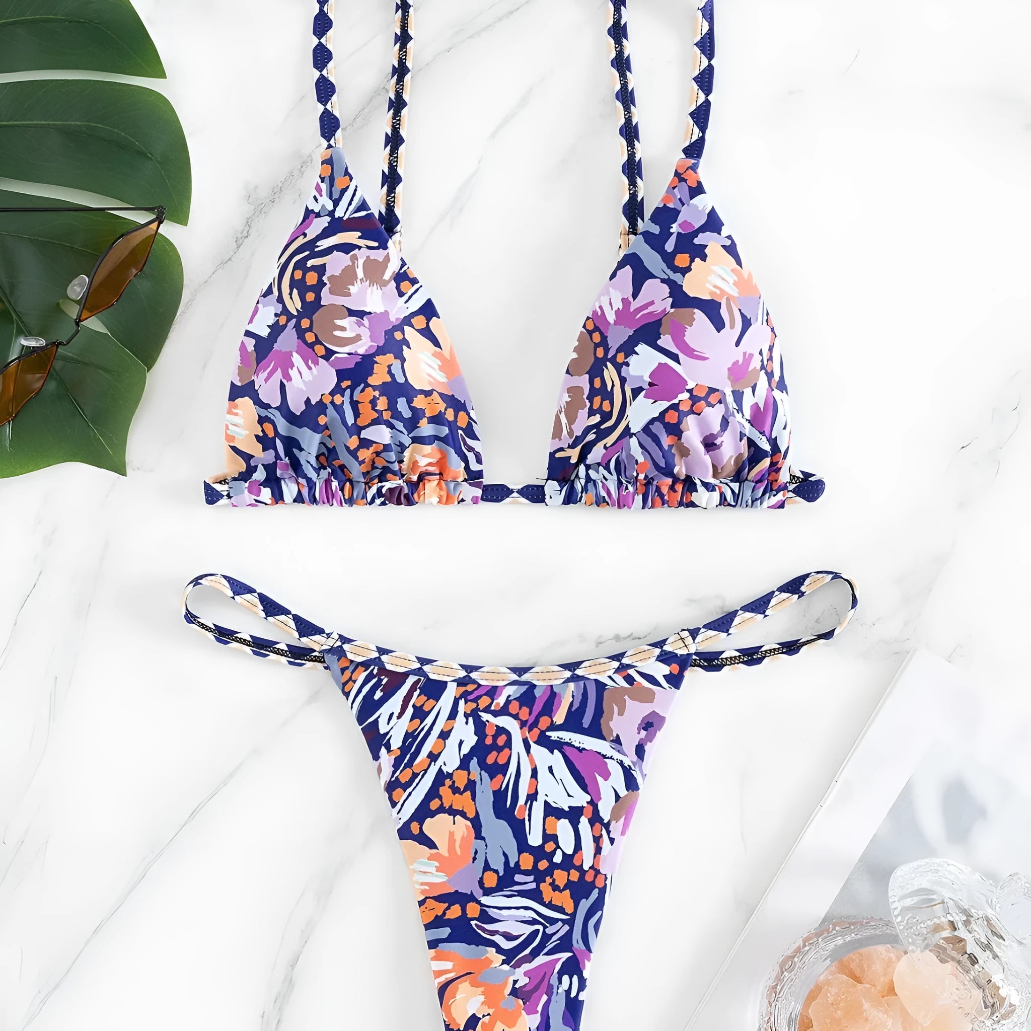 Women's floral print one-piece swimsuit with triangle bag design and split back in polyester.
