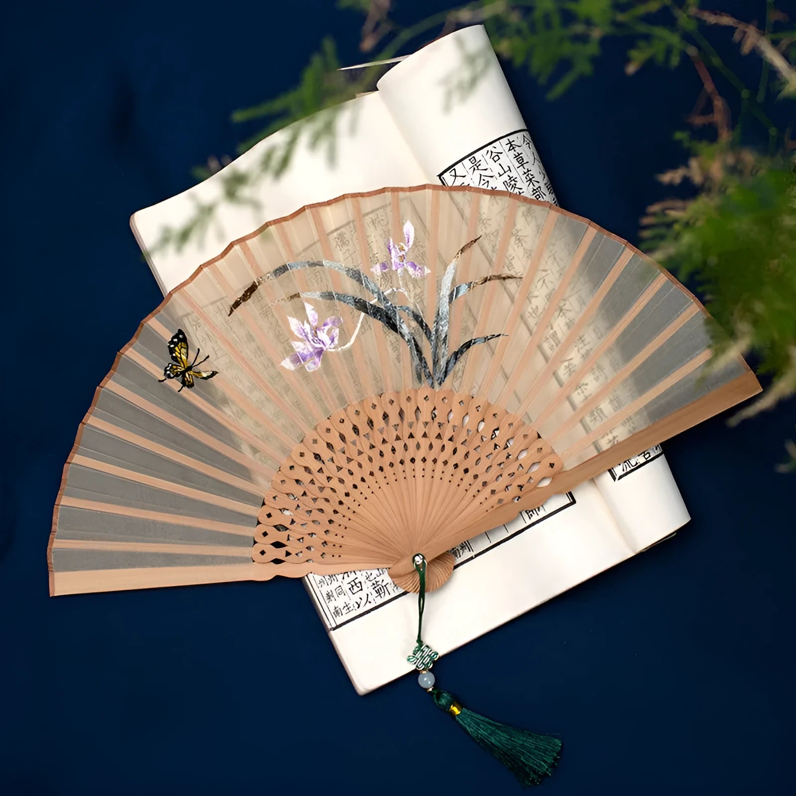 Bamboo folding fan with silk embroidery showing traditional Chinese patterns