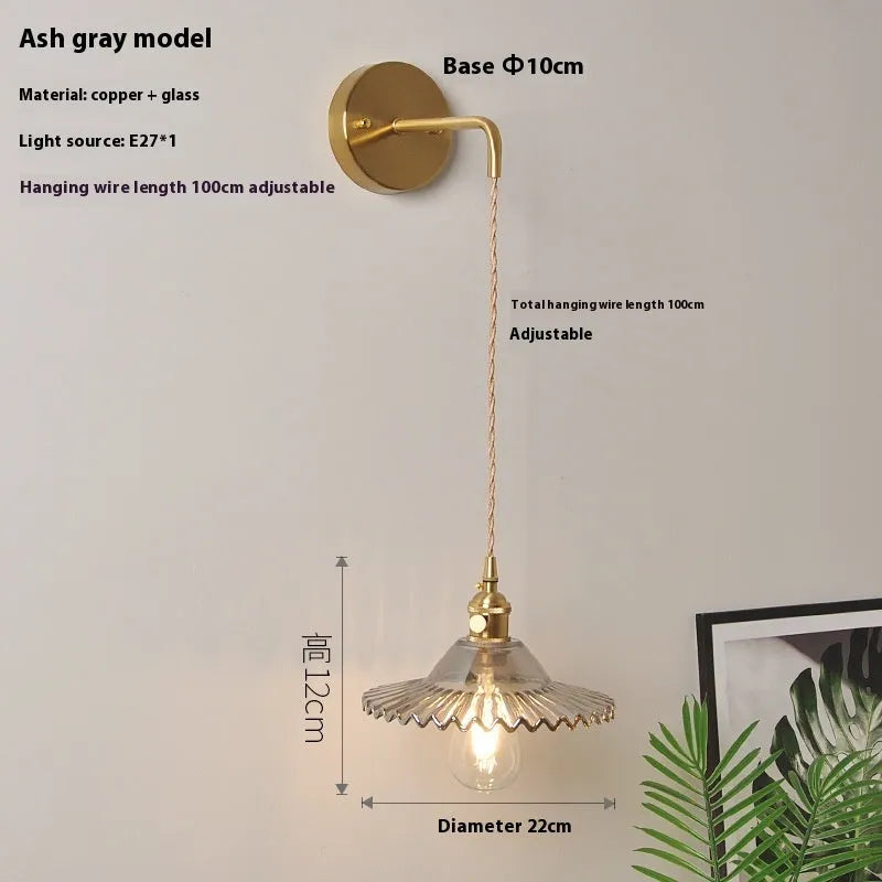 Retro copper lotus wall lamp with glass shade in choice of six colours on a wall.