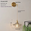 Retro copper lotus wall lamp with glass shade in choice of six colours on a wall.