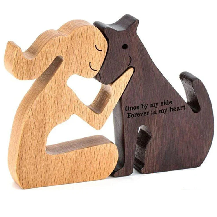 Handcrafted wooden dog sculpture featuring a man and his loyal canine companion