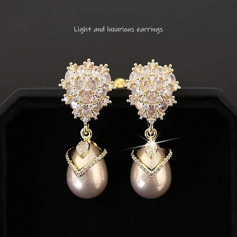 Women's drop-shaped pearl earrings with gemstone inlay in three colour variations