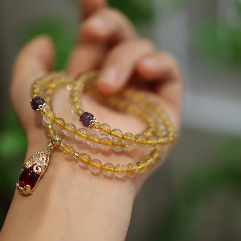 Natural Brazil rutilated quartz bracelet with golden needles and Chinese style hanging chopsticks design