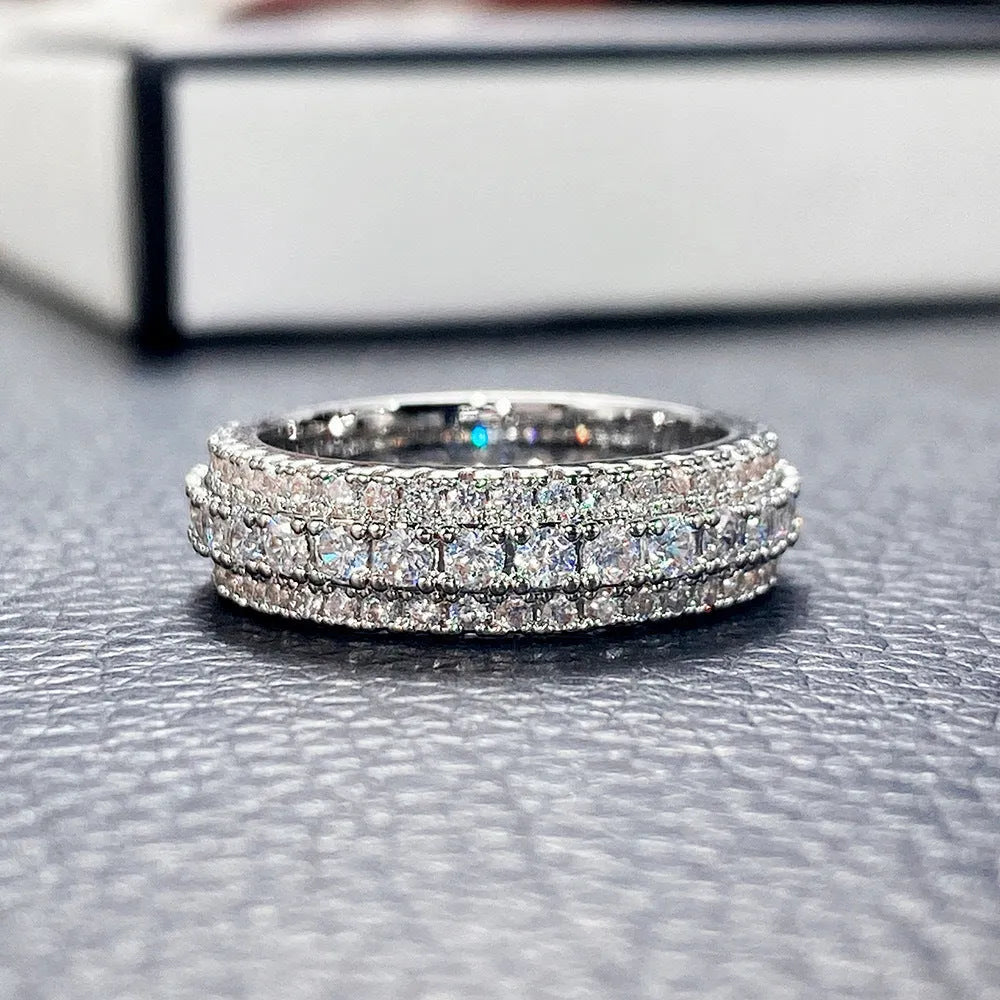 Geometric triangle zircon inlay ring in white gold, yellow gold, and white and black finishes on a copper band.