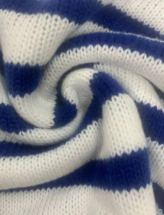Sapphire blue striped loose fit pullover sweater with round neck and long sleeves on a hanger.