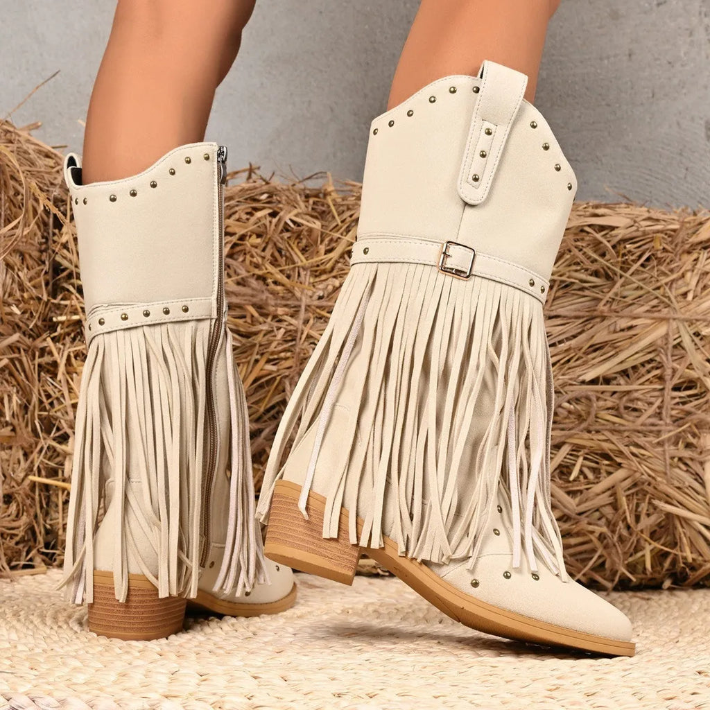 Beige women's western cowboy boots with mid heel, side zipper, and tassel details on a white background