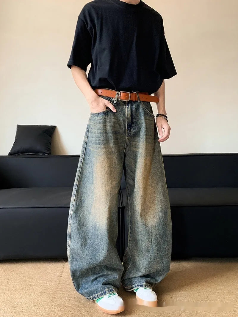 Men's retro blue distressed denim jeans with a slimming wide-leg fit and machete wash detail.