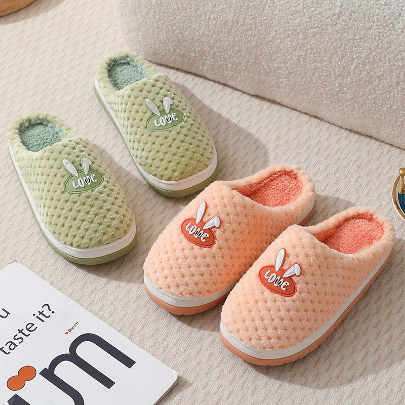 Rabbit plaid design artificial fur house slippers with a non-slip rubber sole.