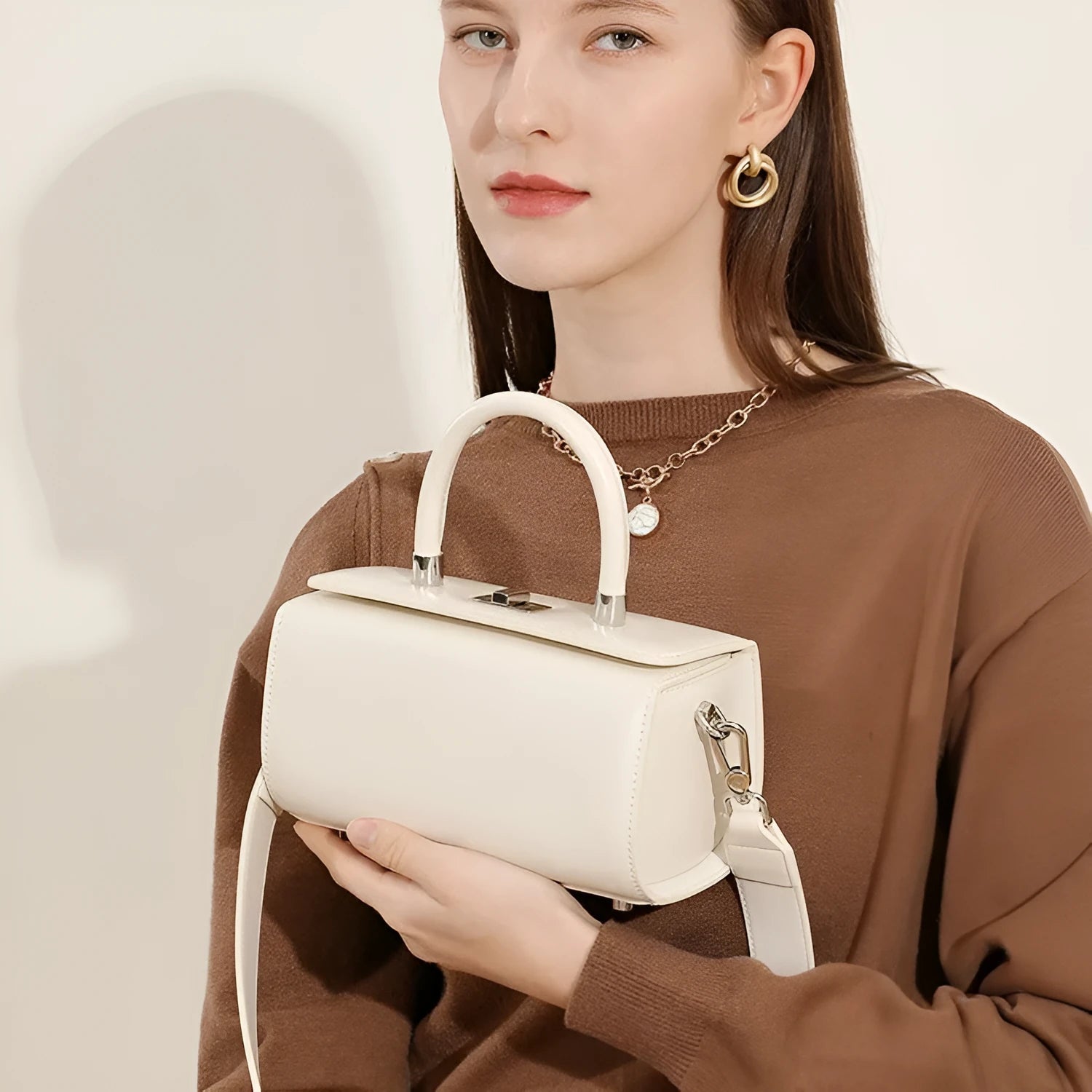 Genuine cowhide leather women's crossbody bag with clamshell opening in black colour showing internal phone and document pockets