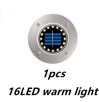 8LED waterproof solar garden light staked in lawn with warm glow, IP65 rated for rain resistance